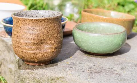Immerse yourself in the elegance of a tea ceremony setting with clay bowls, a Stock Photos