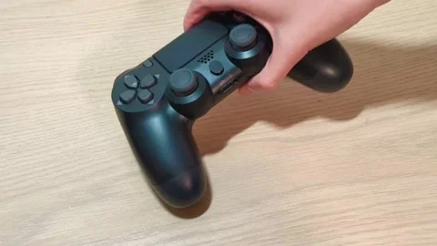 Immerse yourself in the gaming zone with this sleek black wireless gamepad ready Video stock 318310905