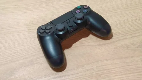 Immerse yourself in the gaming zone with this sleek black wireless gamepad ready Stockbeeldmateriaal 318317283