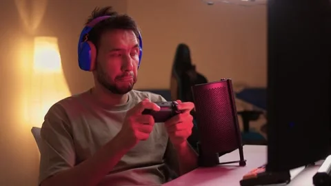 Immerse yourself in an intense gaming experience, all while enjoying a cozy Stock Footage 315140719