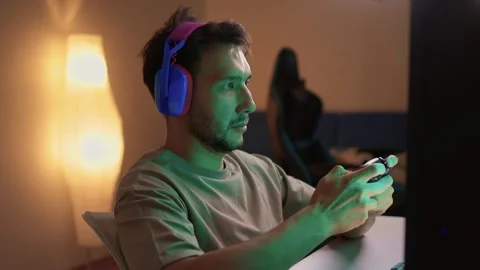 Immerse yourself in an intense gaming experience, all while enjoying a cozy Stock Footage 315140949