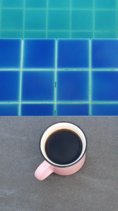Immerse yourself in peaceful poolside ambiance as you enjoy cup of coffee Stock Footage 277865864