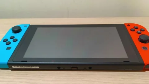 Immerse yourself in seamless gaming with this innovative portable console, Video stock 318310989