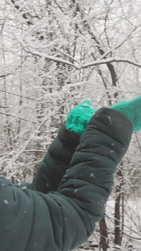 Immerse yourself in a tranquil winter scene with a serene woman in a green hat 스톡 동영상 284708792