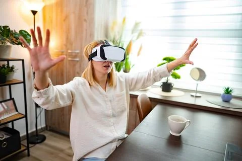 Immersed in virtual reality experience at home during a quiet afternoon Stock Photos