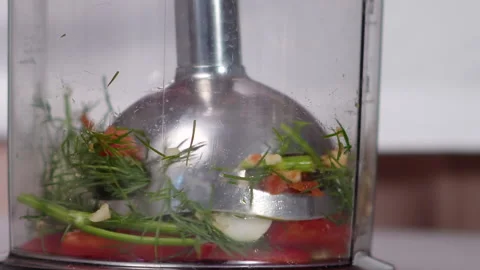 Immersion blender grinds vegetables Video stock 165664795