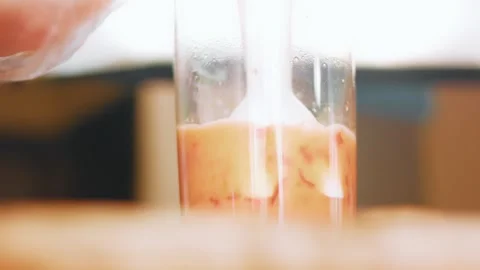 Immersion blender processing pepper mixture in a tall beaker, 4K Stock Footage 341122512