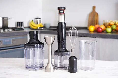 Immersion hand blender on table on a kitchen background. Electric hand mixer Stock Photos