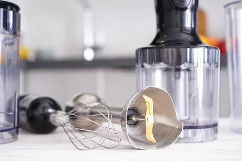 Immersion hand blender on table on a kitchen background, close-up. Stock Photos