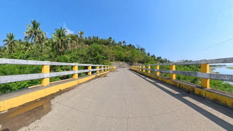Immersive 4K POV Driving over River Bridge, Heading toward Scenic Mountains Stock Footage 337266268
