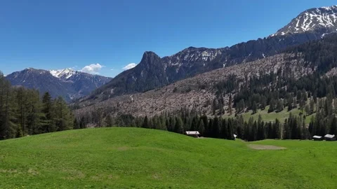 Immersive Aerial Tracking Flight Toward a Sunlit Mountain Valley and Alp Vídeo Stock 338158070