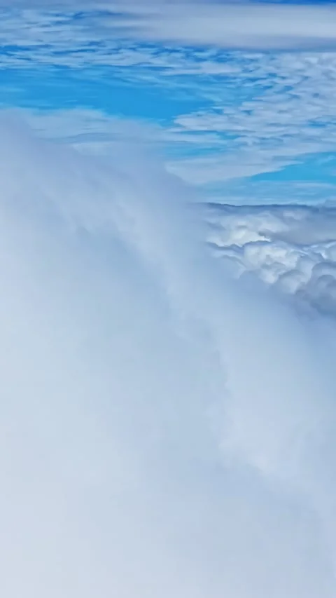 Immersive flight entering a dense wall of white fluffy cloud high in the Stock Footage 337388032