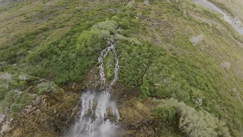 Immersive FPV Drone Waterfall Dive: High Altitude Ridge to Canyon Floor Stock Footage 331896607