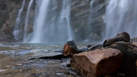 Immersive Low Angle Slow Motion Of Wet Rocks And Powerful Waterfall Stock Footage 340470363