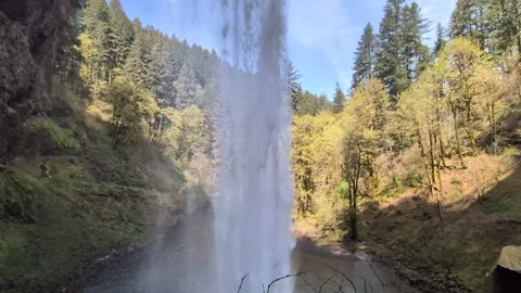 Immersive video captures a towering waterfall from below as water crashes Stock-Footage 337001635