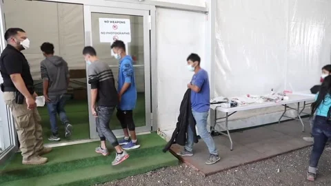 Immigrants entering temporary processing facility in Donna, Texas Stock Footage 151251835