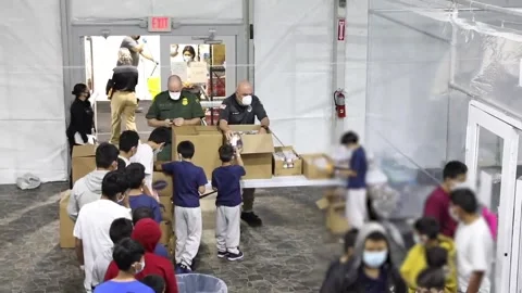 Immigrants queueing for food at temporary processing facility in Donna, Texas Stock Footage 151251782