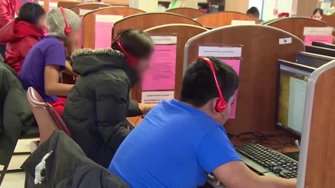 Immigrants using computers at Texas family residential immigration center Stock Footage 114555703