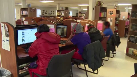 Immigrants using computers at Texas family residential immigration center Stock Footage 114555714