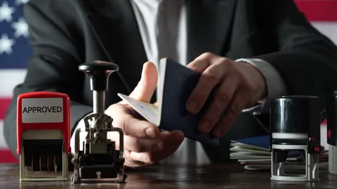 Immigration border control officer will arrival stamp in passport at airport Stock Footage 268977333