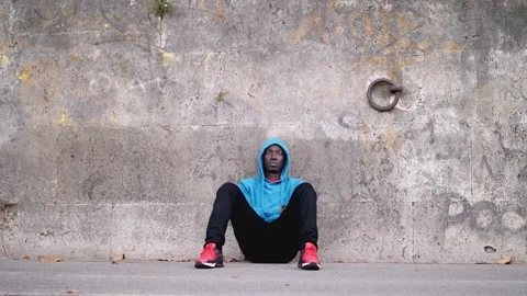 Immigration, problems -sad black man sitting on the sidewalk with catatonic look Stock Footage 231689203