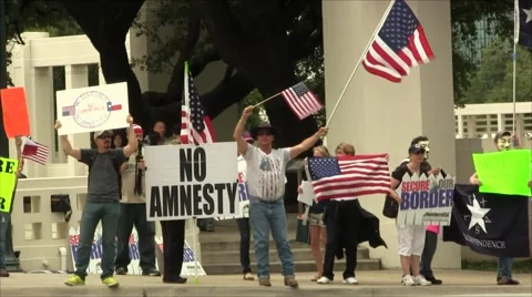Immigration Protest Man with 2 US Flags Stock Footage 57464082