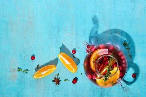 Immunity boosting drink. Tea with cranberries, orange and spices in glass teapot Stock Photos