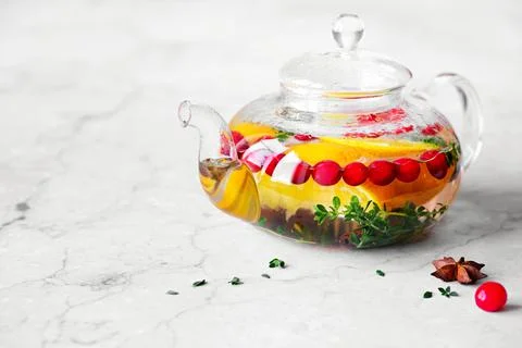 Immunity boosting drink. Thyme Tea with cranberries, orange and spices in glass Stock Photos