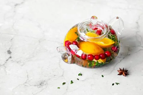 Immunity boosting drink. Thyme Tea with cranberries, orange and spices in glass Stock Photos