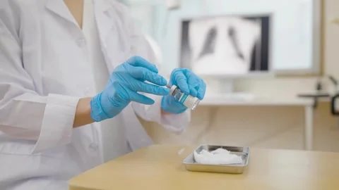 Immunization Closeup of syringe drawing medicine from a bottle Covid-19 Stock-Footage 336586944