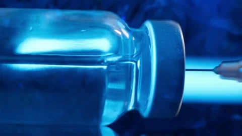 Immunization Closeup of syringe drawing medicine from a bottle Covid-19 Stock-Footage 336587339