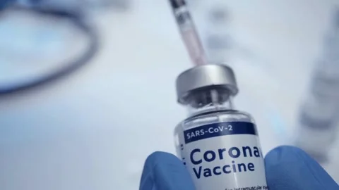 Immunization Closeup of syringe drawing vaccine from a bottle Covid-19 Stock-Footage 336587122