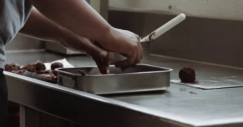 Immxed race man makes a chocolate sweets in industrial kitchen. Stock Footage
