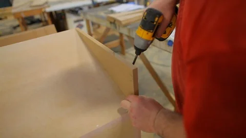 Impact driver being used by construction worker assembling cabinets Stock Footage 125491865