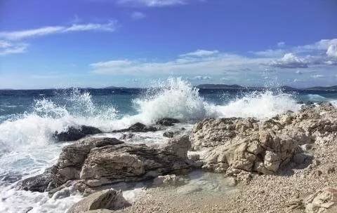 Impact of large waves against rocks in the beach Stock Photos
