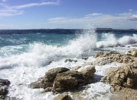 Impact of large waves against rocks in the beach Stock Photos