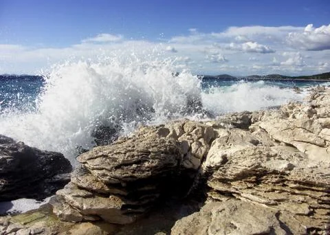Impact of large waves against rocks in the beach Stock Photos