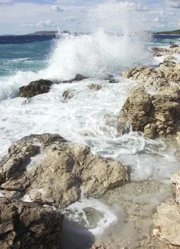 Impact of large waves against rocks in the beach Stock Photos