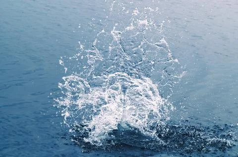 Impact splash on water surface Stock Photos