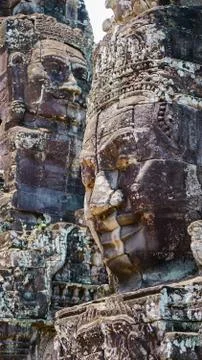 An impactful shot of the ruined ancient faces at Bayon Temple Stock Photos