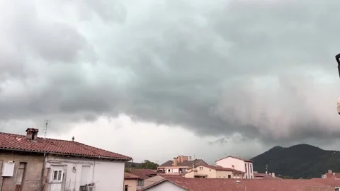 Impending shelf cloud bringing a storm over Olot, Spain Stock Footage 345047497
