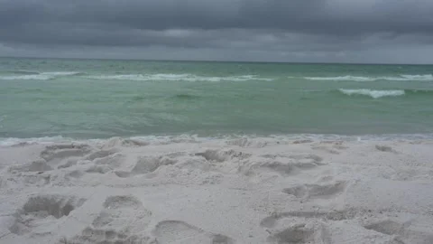 Impending storm clouds gathering over an ocean beach and rough waves Stock Footage 345689560