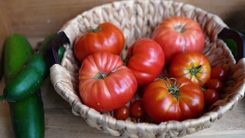 Imperfect tomatoes  and cucumbers in the straw basket Stock Footage 204045754