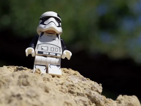An Imperial stormtrooper on a sandy surface. A plastic minifigure Stock Photos
