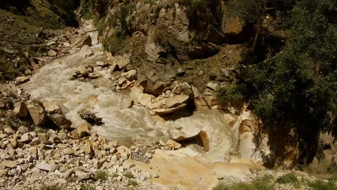 Impetuous mountain river tributary of Ganges in stony gorge sunny summer day Stock Footage 106110939