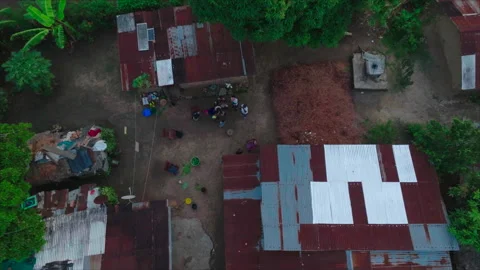 Impfondo, Congo - June 18, 2025: Wide drone descending toward group of people Stockbeeldmateriaal 331999600