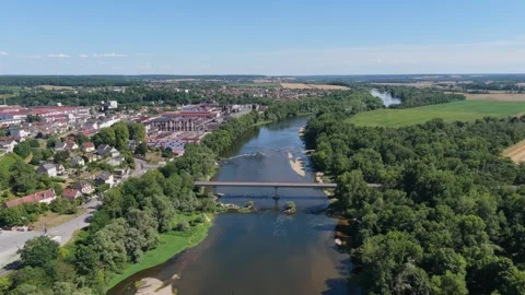 Imphy, France, featuring a river winding through the town, a bridge crossing the Stock Footage 346714285