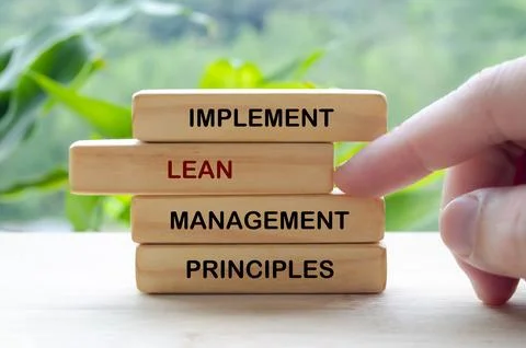 Implement Lean Management Principles text on wooden blocks representing con.. Stock Photos