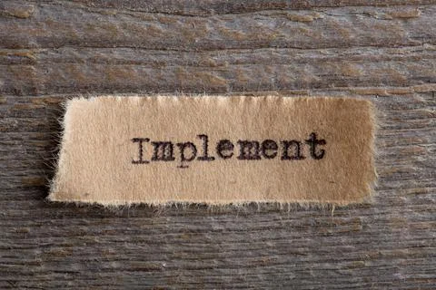 Implement - word on a piece of paper close up, business creative motivation c Stock Photos