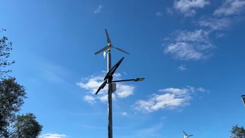 Implementing street lamps that use solar and wind energy can significantly Stock Footage 316834827